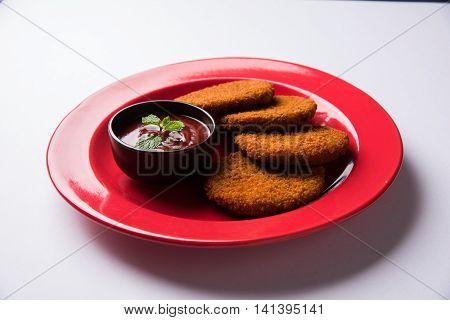 Indian chat item aloo or aalu tikki or tikiya or fried potato cake also known as ragda patties served with tomato ketchup, selective focus