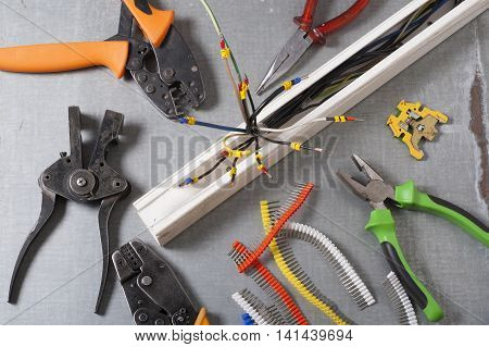 Set of electrical tool on wooden background. Accessories for engineering work, energy concept