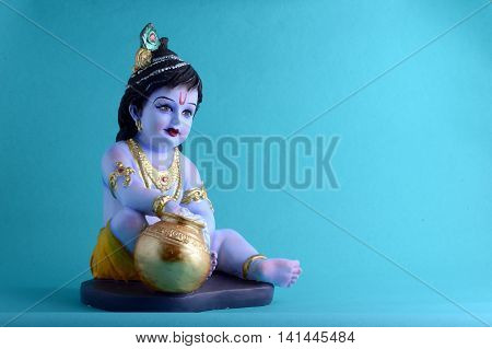 Hindu God Krishna on blue background. Greeting card Design. Space for Headline and Copy.