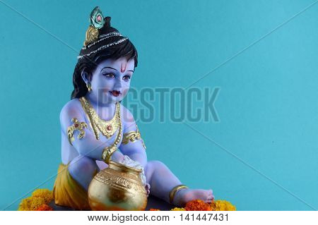 Hindu God Krishna on blue background. Greeting card Design. Space for Headline and Copy.