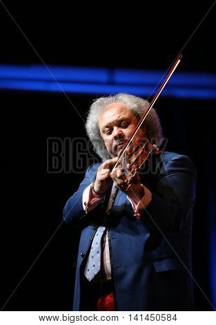CRACOW POLAND - JUNE 11 2016: Roby Lakatos Romani violinist from Hungary playing live music at Summer Jazz Festival in Cracow Poland