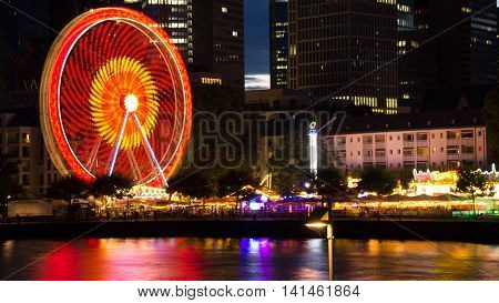Frankfurt, Germany - August 05: Ferris wheel and rides in Frankfurt's mainfest in 2016