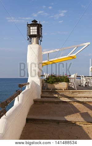 Terrace of a restaurant bar in front the mediterranean sea in Roc de Sant Gaieta Roda de Bera Tarragona Spain.