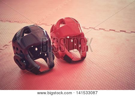Taekwondo head guard on a training mat in old vintage tone