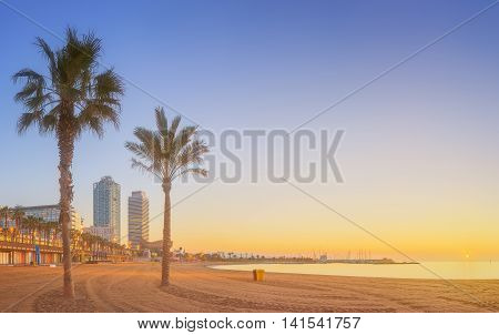 Barceloneta Beach in Barcelona with colorful sky at sunrise