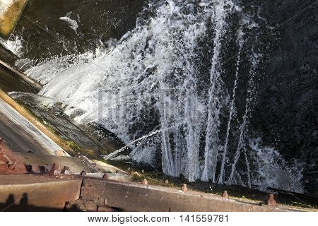 photographed close-up of the old wooden dam, which formed holes flowing dam
