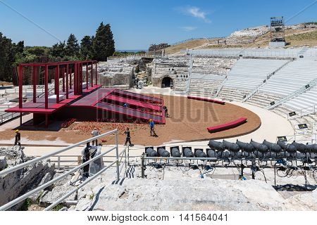 SIRACUSA ITALY - MAY 18: Workers preparing a stage for a performance in the old Greek theatre of Syracusa on May 18 2016 at the island Sicily Italy