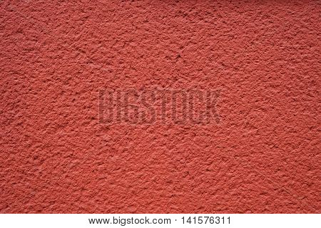 roughcast plaster wall background texture in red