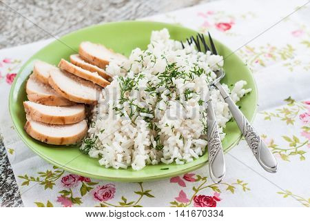 White Rice With Greens And Sliced Pieces Of Meat Grilled On A Green Plate