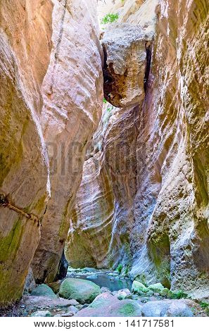 The huge boulder sandwiched between two rocks hangs over the narrow Avakas Gorge Paphos Region Cyprus.