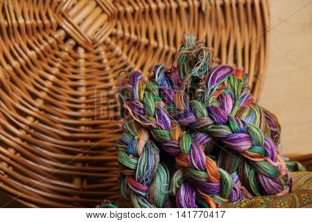 Embroidery threads of every color on brown background