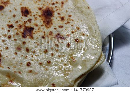 Overhead view of buttered Kulcha with copy space