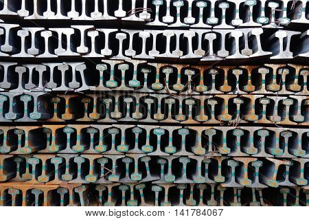 New rails stacked in a pile and form a pattern.