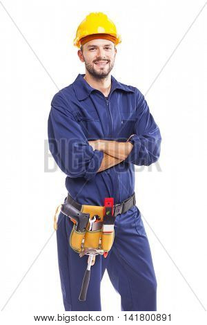 Smiling worker with arms crossed on white background