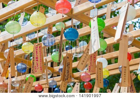 KAWAGOE JAPAN - 20 JULY 2016 - Glass wind chimes hang from wood structure at Hikawa Shrine in Kawagoe town Japan on July 20 2016.