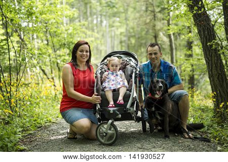 A Family with Cute Baby girl Nature in the Forest