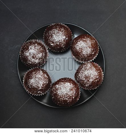 Homebaked Chocolate Muffins For Easter With Colored Conffeti. Dark Background.