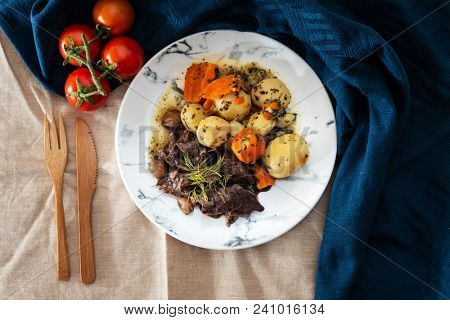 Beef meat stewed with potatoes-Traditional French cuisine Beef Bourguignon potatoes carrots in persillade
