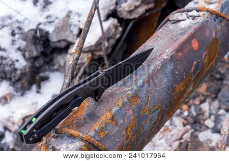 Black Knife On Rust. Top View.