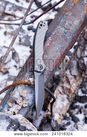 A Pocket Knife With A Black Blade. Vertical Shot.