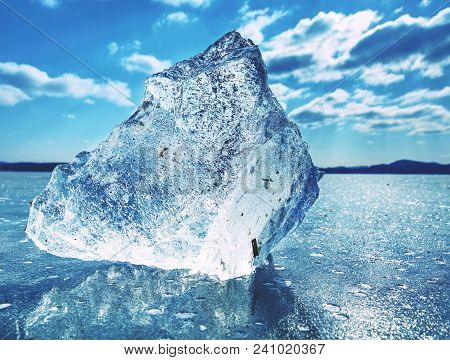 Big Piece Of Ice With Abstract Cracks Inside. Icicle Block Indetail With Frozen Bubbles And Rich Str
