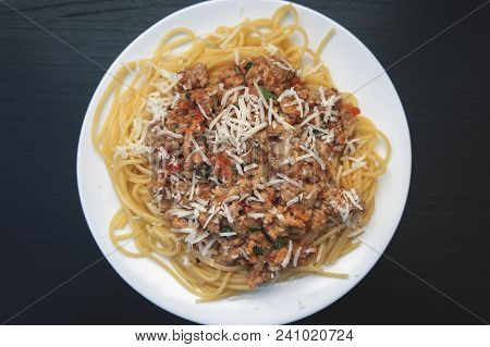 Appetizing Spaghetti In A Plate With Bolognese Sauce On A Dark Background