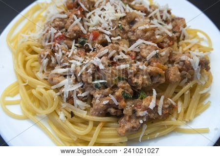 Appetizing Spaghetti In A Plate With Bolognese Sauce On A Dark Background Close Up
