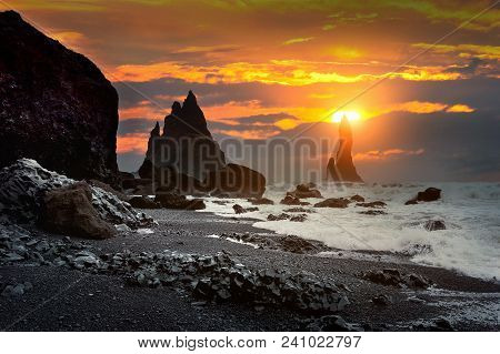 Vik And Basalt Columns At Sunset, Black Sand Beach In Iceland.