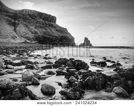 Tranquil Stony Bay In Scotland After Sunset.  Slow Shutter Speed For Smooth Water Level And Dreamy E