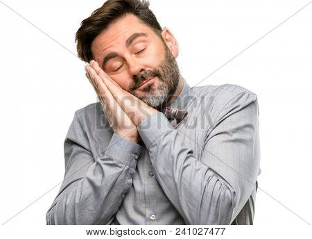 Middle age man, with beard and bow tie tired and bored, tired because of a long day overworking isolated over white background