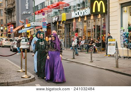 Berlin, October 1, 2017: Group Of Positive Women - Arab Refugees In National Costumes With An Expens
