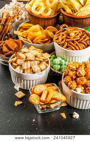 Variation Different Unhealthy Snacks Crackers, Sweet Salted Popcorn, Tortillas, Nuts, Straws, Bretse