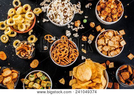 Variation Different Unhealthy Snacks Crackers, Sweet Salted Popcorn, Tortillas, Nuts, Straws, Bretse