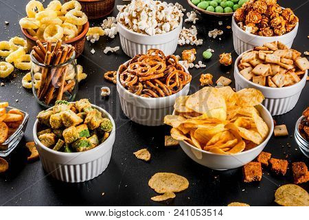 Variation Different Unhealthy Snacks Crackers, Sweet Salted Popcorn, Tortillas, Nuts, Straws, Bretse