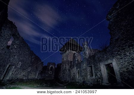 Ruins Of Nevitsky Castle Near Uzhgorod, Ukraine With A Lot Of Shiny Stars On The Dark Blue Sky