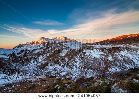 The Top Of The Snow-capped Mountain At Sunrise