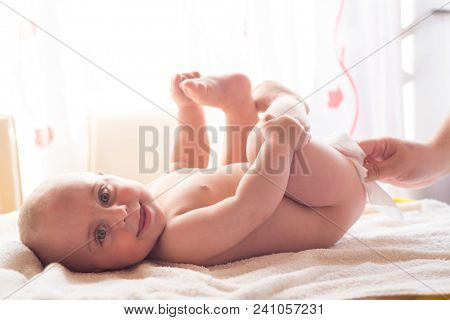 Hygiene - young momy wiping the baby skin with wet wipes. Cleaning wipe, pure, clean
