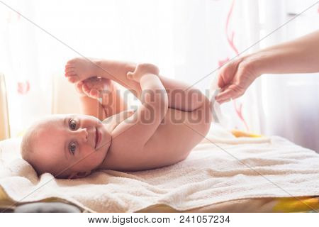 Hygiene - young momy wiping the baby skin with wet wipes. Cleaning wipe, pure, clean
