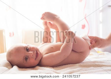 Hygiene - young momy wiping the baby skin with wet wipes. Cleaning wipe, pure, clean