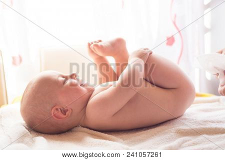 Hygiene - young momy wiping the baby skin with wet wipes. Cleaning wipe, pure, clean