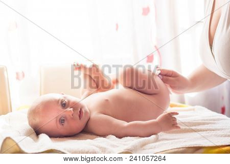 Hygiene - young momy wiping the baby skin with wet wipes. Cleaning wipe, pure, clean