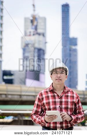 Asian Business And Engineer Man With Red Scott Shirt Has Planning And Working For Design Buiding And