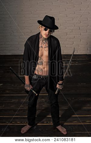 Man With Swords Standing On Wooden Floor Barefoot, Top View. Harakiri, Suicide Ritual. Warrior In Bl