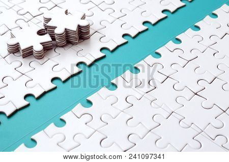 The Blue Path Is Laid On The Platform Of A White Folded Jigsaw Puzzle. The Missing Elements Of The P