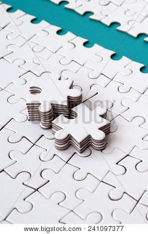 The Blue Path Is Laid On The Platform Of A White Folded Jigsaw Puzzle. The Missing Elements Of The P