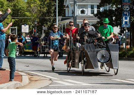 Lawrenceville, Ga - April 2018:  A Team Dressed Like Characters From The Batman Comics, Pushes A Bed