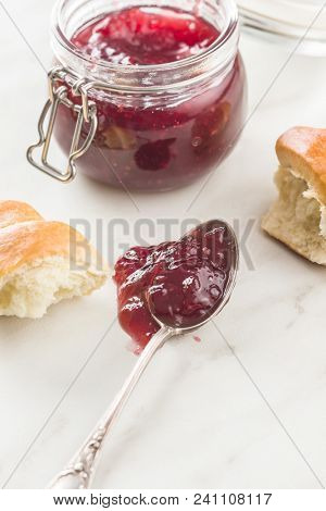 Tasty raspberry jam jelly in spoon.