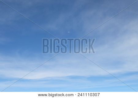Upper Half Moon On The Cloudy Blue Sky