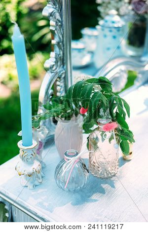 Decorated Console Mirror With Candles, Perfume Bottles And Other Makeup