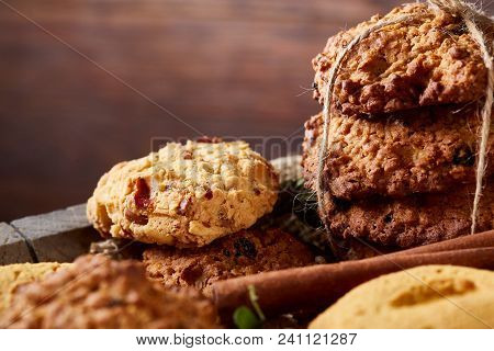 Conceptual Composition With Assortment Of Cookies On Burlap Napkin Covering A Wooden Barrel Over Rus